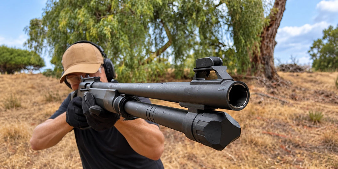Shooter with hearing protection firing a Sulun Arms shotgun at an outdoor range